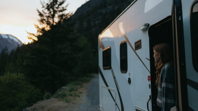 Women looking out of RV door at mountain sunset